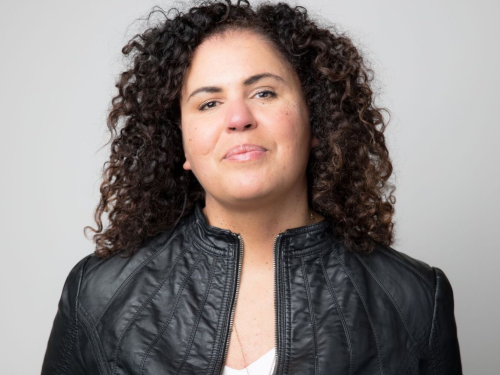 safiya noble, a woman with curly brown hair and a black leather jacket