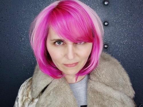 jessica romeo, white woman in a grey jacket with pink hair 